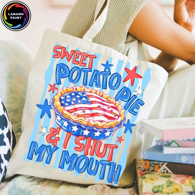 May include: A cream-colored tote bag with the words "Sweet Potato Pie & I Shut My Mouth" in red and blue. The design includes a pie with an American flag design and blue stars.
