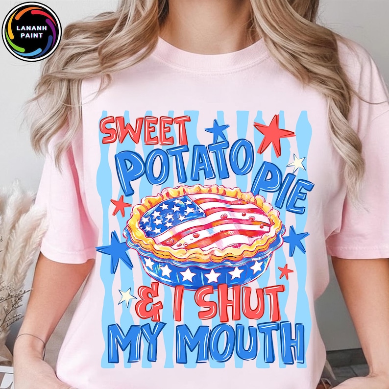 May include: Pink t-shirt with a graphic of a sweet potato pie decorated with the American flag, surrounded by stars and the text "Sweet Potato Pie & I Shut My Mouth."