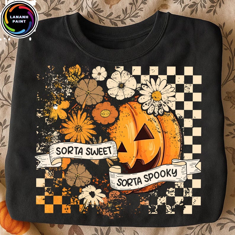 May include: Black sweatshirt with a Halloween-themed design. Features a jack-o'-lantern with the text "Sorta Sweet Sorta Spooky" on a banner. The design includes flowers and a checkered pattern.