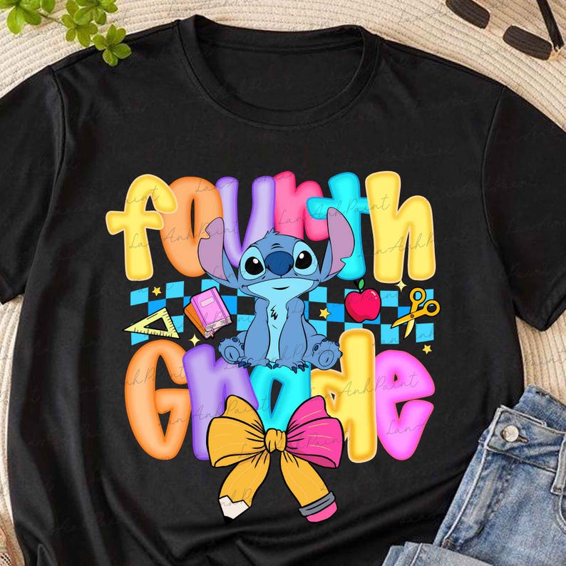 May include: A black t-shirt featuring a colorful graphic with the text "fourth grade" in bubble letters. The design includes a blue alien character, a red apple, a yellow pencil bow, a ruler, a book, and a blue and black checkered background pattern.