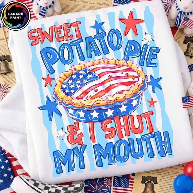 May include: White sweatshirt with a colorful graphic of a sweet potato pie decorated with the American flag. The text reads "Sweet Potato Pie & I Shut My Mouth" in red and blue. Patriotic theme.