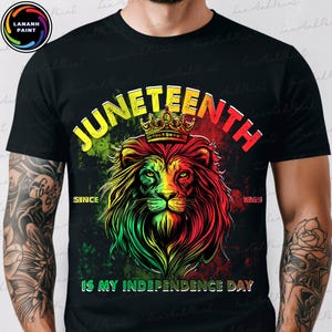 May include: Black t-shirt with a vibrant lion graphic wearing a crown, and the words "JUNETEENTH" in yellow and red. The shirt also displays "SINCE 1865" and "IS MY INDEPENDENCE DAY".