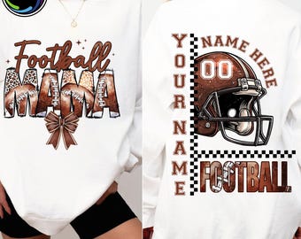 May include: White sweatshirt with "Football MAMA" in brown and leopard print lettering, football graphics, and a brown bow. The back features a football helmet graphic with the text "YOUR NAME HERE" and "FOOTBALL".