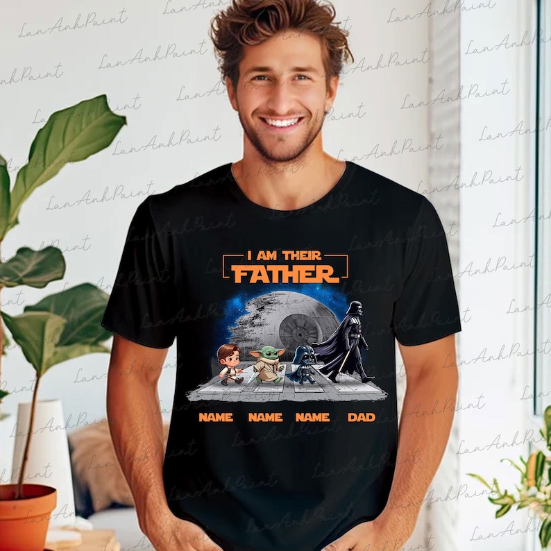 May include: Black t-shirt featuring a graphic with the text "I AM THEIR FATHER" above an image of characters from a popular science fiction franchise. The graphic includes the Death Star and the text "NAME NAME NAME DAD".