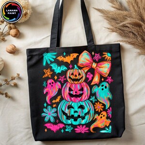 May include: Black tote bag featuring a colorful Halloween design. The design includes stacked jack-o'-lanterns, ghosts, bats, flowers, and a large bow. The bag has black handles and the brand name "LANANH PAINT" in a circle.