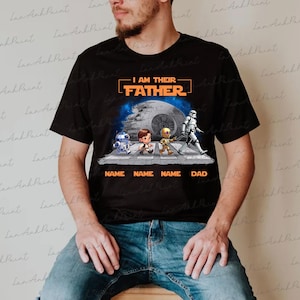 May include: Black t-shirt featuring a Star Wars-themed design. The graphic includes the text "I AM THEIR FATHER" above cartoon characters crossing a street. Below the characters are the words "NAME NAME NAME DAD".
