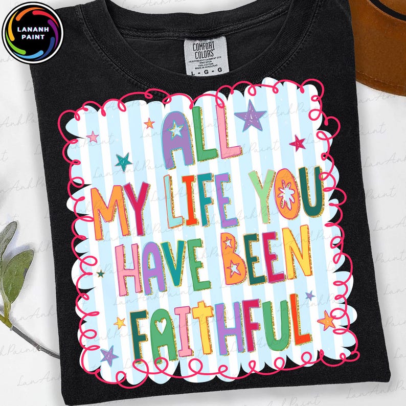 May include: Black t-shirt with a colorful graphic that reads "ALL MY LIFE YOU HAVE BEEN FAITHFUL." The design features a light blue background with white stripes, a pink scalloped border, and stars.