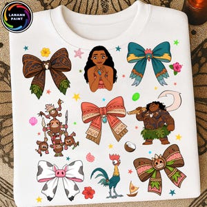 May include: A white t-shirt featuring a colorful graphic print of Moana characters, including Moana, Maui, Hei Hei, and Kakamora, interspersed with decorative bows, tropical flowers, seashells, and stars. The logo LANANH PAINT is in the top corner.