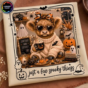 May include: A square canvas print featuring a fluffy Highland cow wearing a patterned bow and heart-shaped glasses, holding a pumpkin-themed mug. The scene includes ghosts, pumpkins, and text reading "STAY COZY AND SPOOKY" and "just a few spooky things."