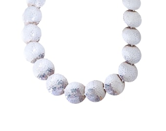 May include: A silver necklace with round, textured beads. The beads are all the same size and are arranged in a single strand.