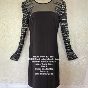 May include: Black sheath dress with sheer beaded top and long sleeves. The dress has a back zip and is lined below the yoke. The bust measures 32 inches. The dress is a BASIX Black Label from the 1990s, size 2.