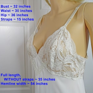 May include: White lace lingerie slip with adjustable straps. Bust: 32 inches, Waist: 30 inches, Hip: 36 inches, Straps: 15 inches. Full length without straps: 35 inches, Hemline width: 54 inches.