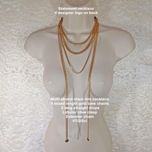 May include: A gold-tone multi-strand chain link necklace with four mixed-length chains and two long straight drops. The necklace has a lobster claw clasp and an extender chain. The text on the image says "Statement necklace" and "VTGific!"