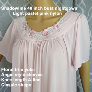 May include: A light pastel pink nylon nightgown with a floral trim yoke, angel style sleeves, knee length A-line shape, and the text "Shadowline 40 inch bust nightgown Light pastel pink nylon".