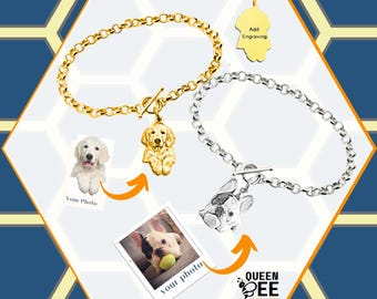 May include: Two gold and silver bracelets with a charm that can be personalized with a photo of your pet. The charms are shaped like a dog and the bracelets have a toggle clasp. The image shows a golden retriever and a French bulldog.