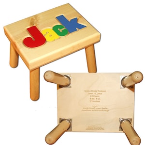 May include: A wooden child's step stool with the name "Jack" spelled out in colorful letters on the top. The bottom of the stool is engraved with a birth announcement for Grace Marie Theissen, including her birth date, time, weight, and length.