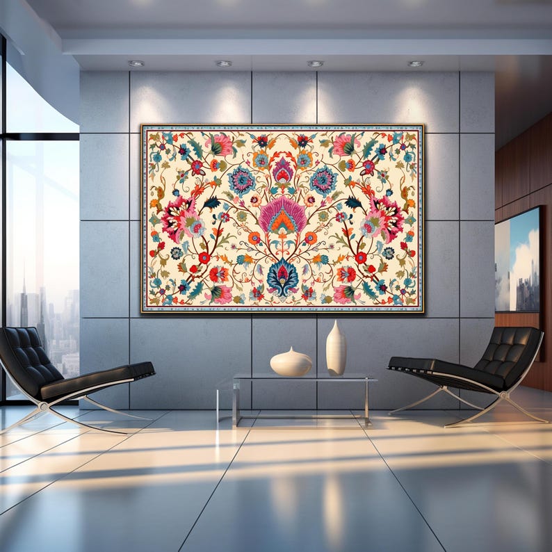 May include: Large framed floral tapestry with a cream background. The tapestry features a symmetrical design with vibrant pink, blue, orange, and green flowers and foliage. The frame is dark brown. The artwork is displayed in a modern living room.