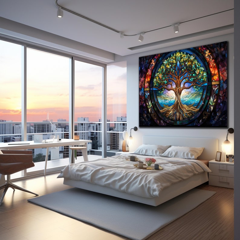 May include: A stained glass style artwork depicting a tree of life with colourful leaves and roots. The tree is surrounded by a circle of blue water and a sunset sky. The artwork is hanging on a white wall in a modern bedroom.