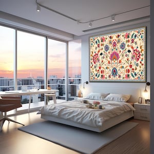 May include: A bedroom with a large floral tapestry above a bed. The tapestry features a cream background with a symmetrical design of colorful flowers in pink, blue, and orange. The room has a large window with a city view.