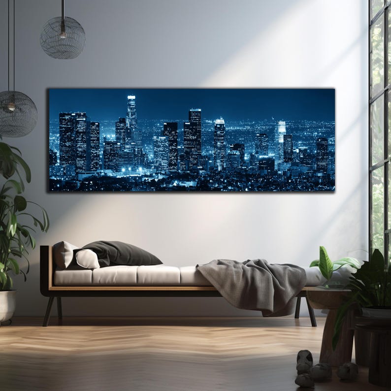 May include: A panoramic canvas print of a cityscape at night, dominated by tall skyscrapers illuminated in shades of blue and white. The artwork captures the urban landscape with a focus on architectural details and city lights.