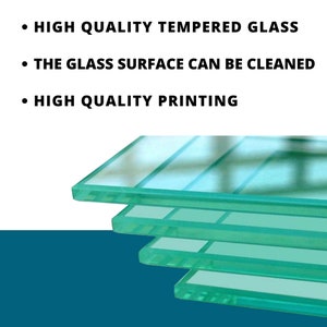 May include: A stack of clear, rectangular glass panels with a slight green tint. The image includes text that reads: "HIGH QUALITY TEMPERED GLASS", "THE GLASS SURFACE CAN BE CLEANED", and "HIGH QUALITY PRINTING".