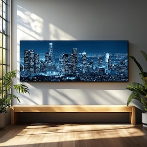 May include: A large, rectangular canvas print depicting a nighttime cityscape in shades of blue. The image showcases illuminated skyscrapers and city lights, creating a modern and urban aesthetic. The print is mounted above a wooden bench.