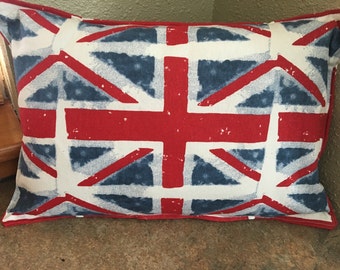 May include: A white pillow with a red, white, and blue Union Jack design. The design is a distressed, faded look.