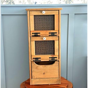 May include: A set of three ceramic mugs with a speckled, matte finish. The mugs are in shades of cream, light gray, and dark gray. Each mug has a simple, minimalist design, perfect for coffee or tea.