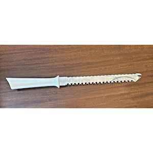 May include: A serrated bread knife with a light blue handle and a stainless steel blade. The blade has a series of sharp teeth along the cutting edge. The knife is designed for slicing bread and other baked goods.