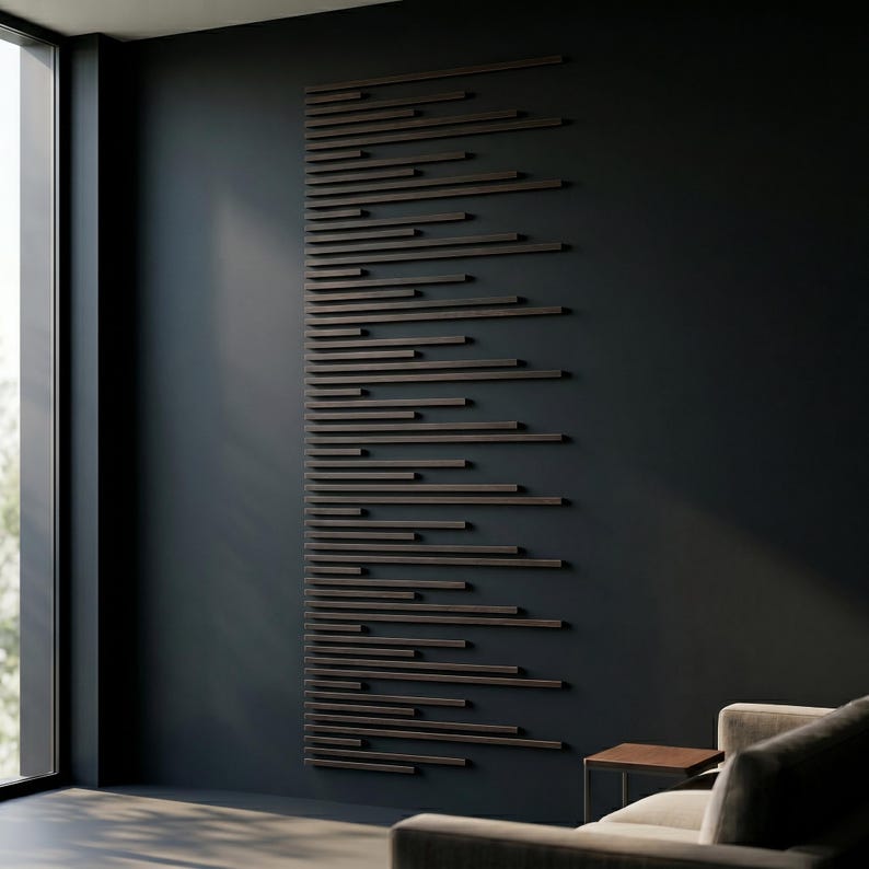 May include: A modern wall art installation featuring numerous horizontal, dark brown wooden slats of varying lengths. The slats are mounted on a dark gray wall, creating a linear pattern. The artwork is displayed in a contemporary living space.
