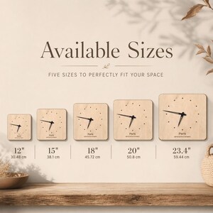 May include: A display of five square wooden clocks, each with black hands and a minimalist design. Sizes range from 12 inches (30.48 cm) to 23.4 inches (59.44 cm), with the word "Paris" and coordinates on each clock face.
