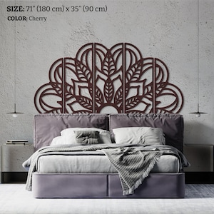 May include: Cherry-colored, laser-cut wooden headboard with a floral mandala design. The headboard is 71 inches (180 cm) wide and 35 inches (90 cm) high. The headboard is mounted above a bed with a gray upholstered headboard.