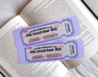 May include: Two purple and blue bookmarks with the text "Lifetime Membership to the Anti Social Book Club" and "Peace & Quiet 100% Guaranteed" and "Absolutely No Social Interaction Allowed". The bookmarks also have the text "Admit One Introvert" on them.