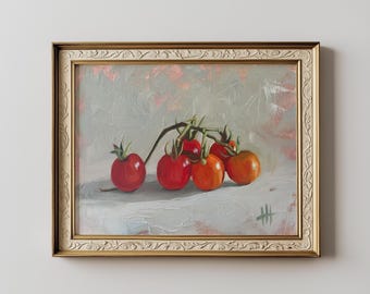 May include: An oil painting of a cluster of ripe red tomatoes on a vine, set against a light gray background. The artwork is framed in a gold-colored, ornate frame, adding a touch of elegance to the still life composition.