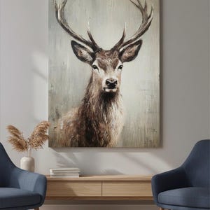 May include: A rectangular canvas print featuring a detailed portrait of a deer with large antlers. The artwork uses a muted color palette of browns and grays, creating a rustic and natural aesthetic. The deer is centered, with a focus on its face.