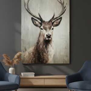 May include: A rectangular canvas print featuring a detailed portrait of a deer with large antlers. The artwork uses a muted color palette of browns and grays, creating a rustic and natural aesthetic. The deer is centered, with a focus on its face and antlers.