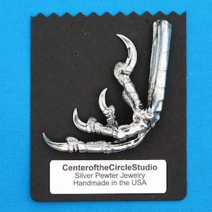 May include: Silver pewter bird claw pendant with detailed talons. CenteroftheCircleStudio Silver Pewter Jewelry Handmade in the USA.