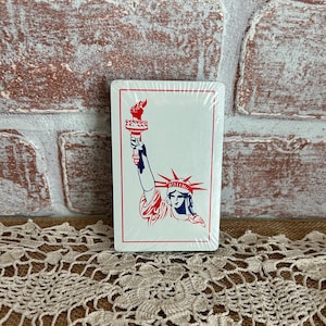 May include: A set of three ceramic mugs with a speckled, matte finish. The mugs are in shades of cream, light gray, and dark gray. Each mug has a simple, minimalist design and a rounded handle.