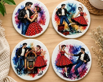 May include: A set of four round ceramic coasters featuring colorful watercolor-style illustrations of a couple in 1950s attire. The designs depict a man in a leather jacket and a woman in a red polka-dot dress dancing, listening to music, and posing.