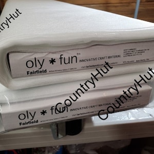 May include: Two rolls of white, soft, and flexible craft material. The packaging is white with black text that reads "oly * fun" and "Fairfield" with the trademark symbol. The text "INNOVATIVE CRAFT MATERIAL" is also printed on the packaging.