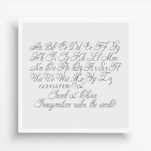 May include: A white canvas print featuring a black cursive font. The print displays the alphabet, numbers, and the phrase "Imagination rules the world!" along with the names "Jacob & Olivia."