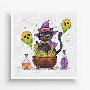 May include: A cross-stitch design featuring a black cat dressed as a witch, wearing a purple hat and cape, stirring a green potion in a cauldron. Two yellow ghosts float nearby, with two potion bottles on either side.