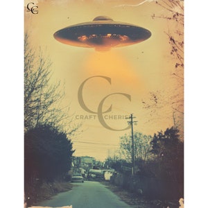 May include: A vintage-style image depicts a UFO hovering over a rural road. The flying saucer is a dark metallic color with illuminated lights. The scene is set against a sepia-toned sky, with trees and a car on the road below. The text "CRAFT CHERISH" is visible.