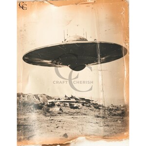 May include: Sepia-toned photograph of a flying saucer hovering over a desert landscape. The spacecraft is a dark, circular shape with a domed top and a central light. The image has a vintage aesthetic, with the text "CRAFT CHERISH" visible.
