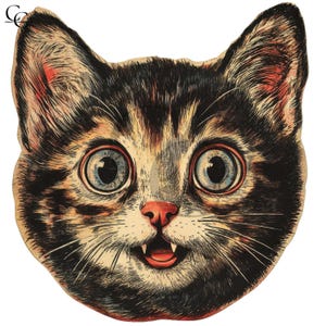 May include: Vintage-style cat face illustration with large blue eyes, a pink nose, and visible teeth. The cat's fur is a mix of black, brown, and tan, with a slightly open mouth. The artwork has a distressed, aged appearance, suggesting a retro or antique aesthetic.