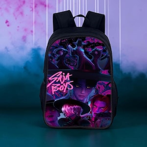 May include: A black backpack featuring a vibrant graphic print of multiple characters in wide-brimmed hats with neon pink and purple accents. The text "SAJA BOYS" is printed in a stylized pink font across the center of the bag's front panel.