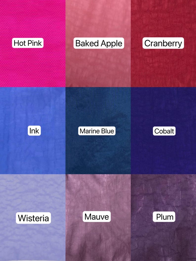 May include: Nine fabric swatches in various colors, each labeled with a color name. Colors include Hot Pink, Baked Apple, Cranberry, Ink, Marine Blue, Cobalt, Wisteria, Mauve, and Plum. The fabric appears to have a textured surface.