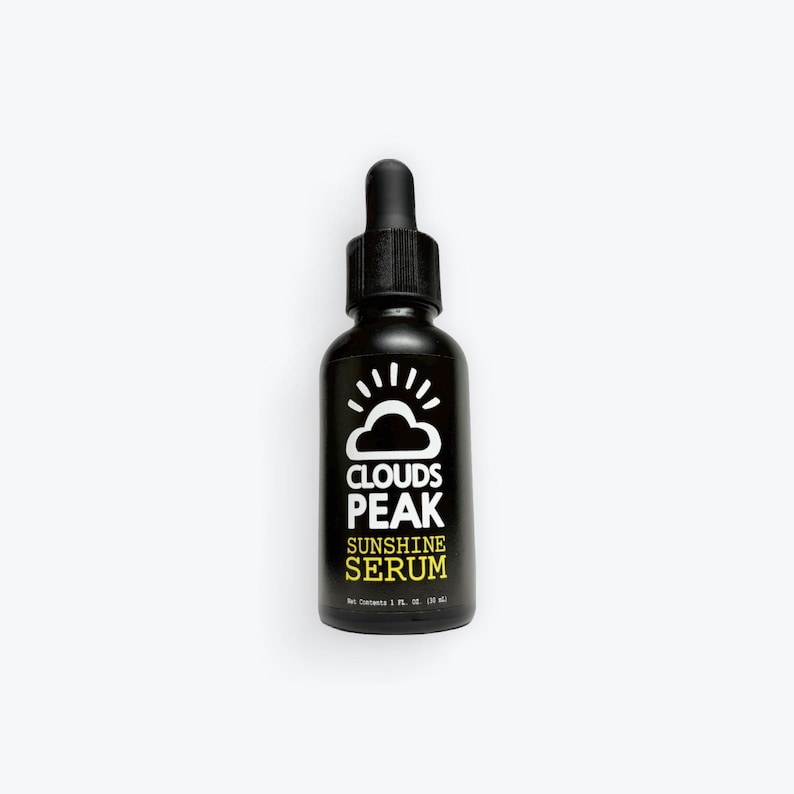May include: A black glass bottle with a dropper top. The label says "Clouds Peak Sunshine Serum".
