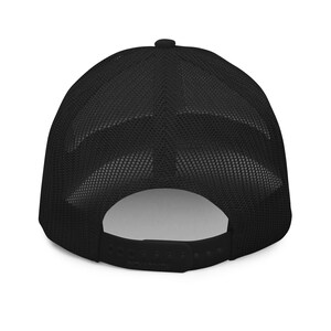 May include: Black mesh trucker hat with a black brim and a black adjustable strap.