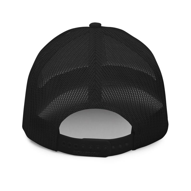 May include: Black mesh trucker hat with a black brim and a black adjustable strap.